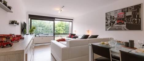 Living room with two sofa beds and balcony