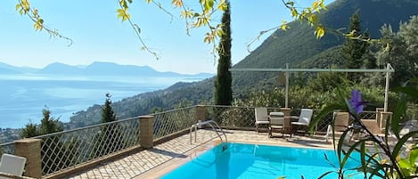 The pool area view from the wooden pergola where the outdoor lounge is located.