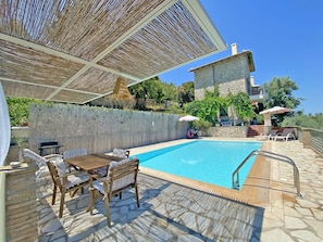 The pool and dining area of Villa Arion.