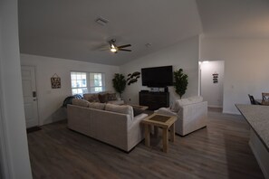 Living area with a 75 inch smart TV