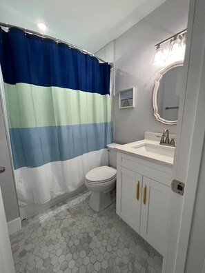 Spacious bathroom with a tub. Shampoo, body wash and conditioner provided