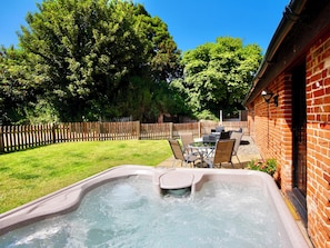 Furnished patio with hot tub