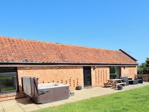 South west facing lawned garden with private hot tub
