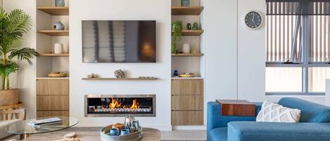 Cosy up by the fireplace in the living room