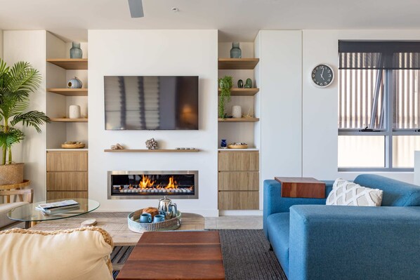 Cosy up by the fireplace in the living room