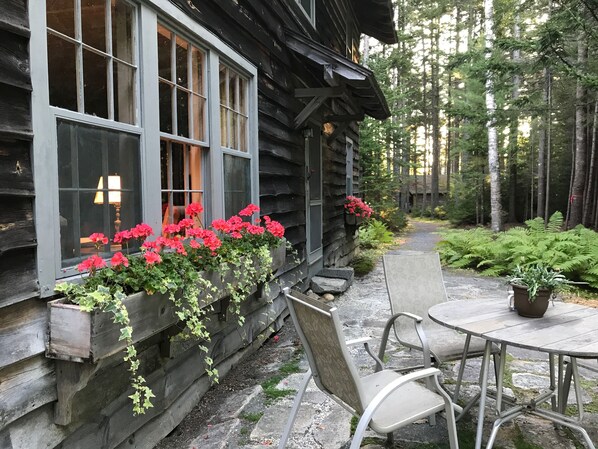 Front of house with traditional window boxes & path to parking 
