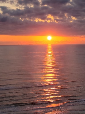 view of morning sunrise from living room/balcony