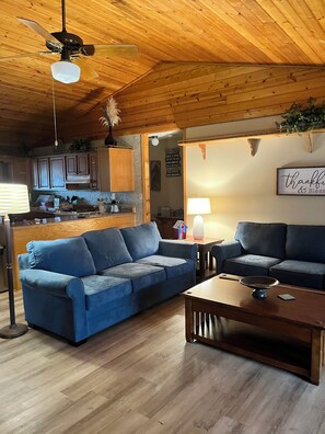 Open living space , kitchen and eating area with new hardwood laminate flooring.