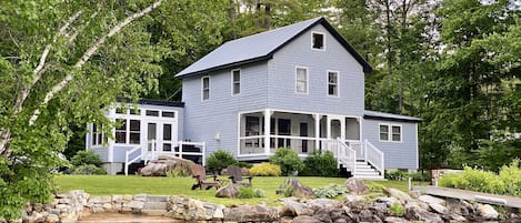 Two-story lakefront cottage w/ primary suite on 1st floor and 3 bdrms on the 2nd