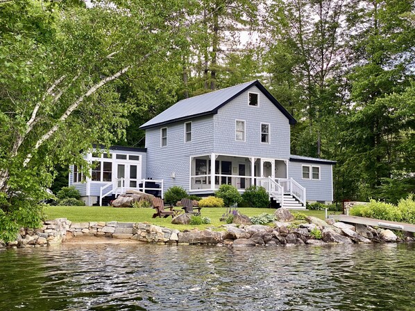 Two-story lakefront cottage w/ primary suite on 1st floor and 3 bdrms on the 2nd
