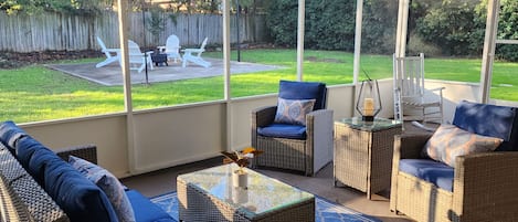 Screened porch overlooking the firepit in the fenced back yard.