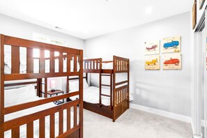 Enjoy a fun and functional space with this third bedroom featuring five twin bunk beds. Perfect for groups or sleepovers, this room offers plenty of sleeping arrangements and a cozy atmosphere for relaxation and activities.