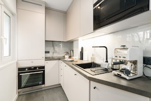 A sleek and fully-equipped kitchen with contemporary fittings and appliances.