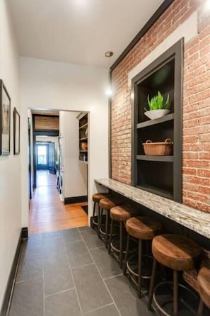 Exposed brick and rich hardwood floors flow throughout