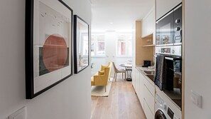 Overview of kitchenette that includes a dishwasher and washing machine #laundry #lovelystay