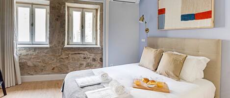 Gorgeous bedroom with exposed stone wall and a comfortable mattress #comfort #lovelystay