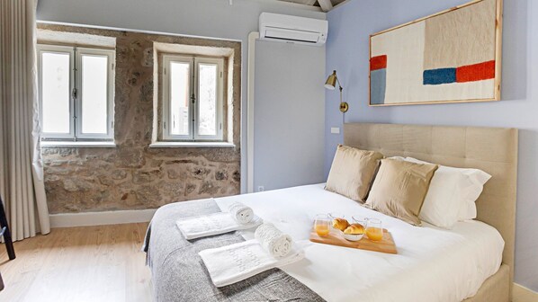 Gorgeous bedroom with exposed stone wall and a comfortable mattress #comfort #lovelystay