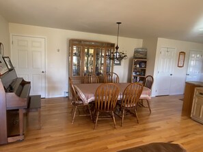 Dining room, seated for six, with access to additional folding chairs if needed.