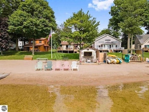 The beach has 50ft of private frontage just steps from the home, with a huge sandy beach for guests to enjoy. It also has a fun Tiki Hut with bar seating, a refrigerator, and more.