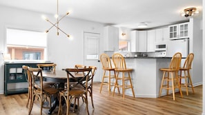 Walking through to the back of the home, you'll find a large open concept living area, featuring the kitchen, dining area, and second living room.