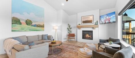 Large Family Room with cozy seating and an electric fireplace 