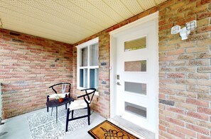 Porch. Frameless tampered glass enclosure with sitting arrangement.