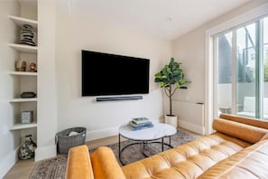 Living Room w 75" smart TV + Sonos ARC w Atmos Surround Sound + comfy sofa