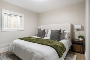 Master Bedroom with brand new Avocado Green King Mattress & luxury bedding, built-in reading & comfort lights, nightstands with charging stations, 55" NeoQLED 4k Smart TV & large built-in closet