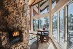 Play chess by the fireplace with a scenic backdrop.