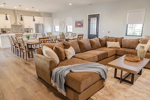 Standing in living room looking towards dining room/kitchen area