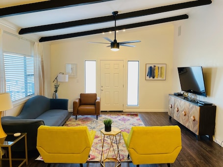 Upstairs living room, balcony access.