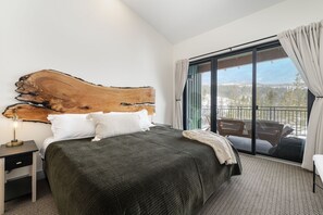 The Primary suite with King bed, access to balcony, and gorgeous mountain views.