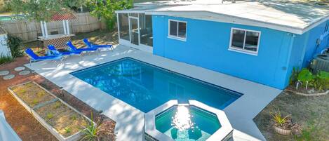 Aerial view of backyard, pool, & patio.