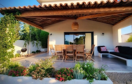 une maison accueillante, avec une grande terrasse couverte, spacieuse et fleurie