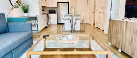 Expansive space with Oak coffee table and comfy modern furnishings.