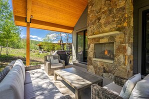 Private patio offering a grill, seating and fireplace