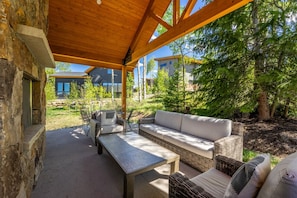 Private patio offering a grill, seating and fireplace