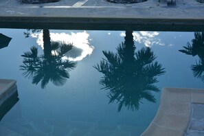 Palm trees reflected in the swimming pool, Cortijos Rey Fini.
