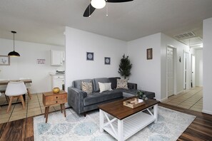 An inviting living room with comfortable seating and a soft couch.