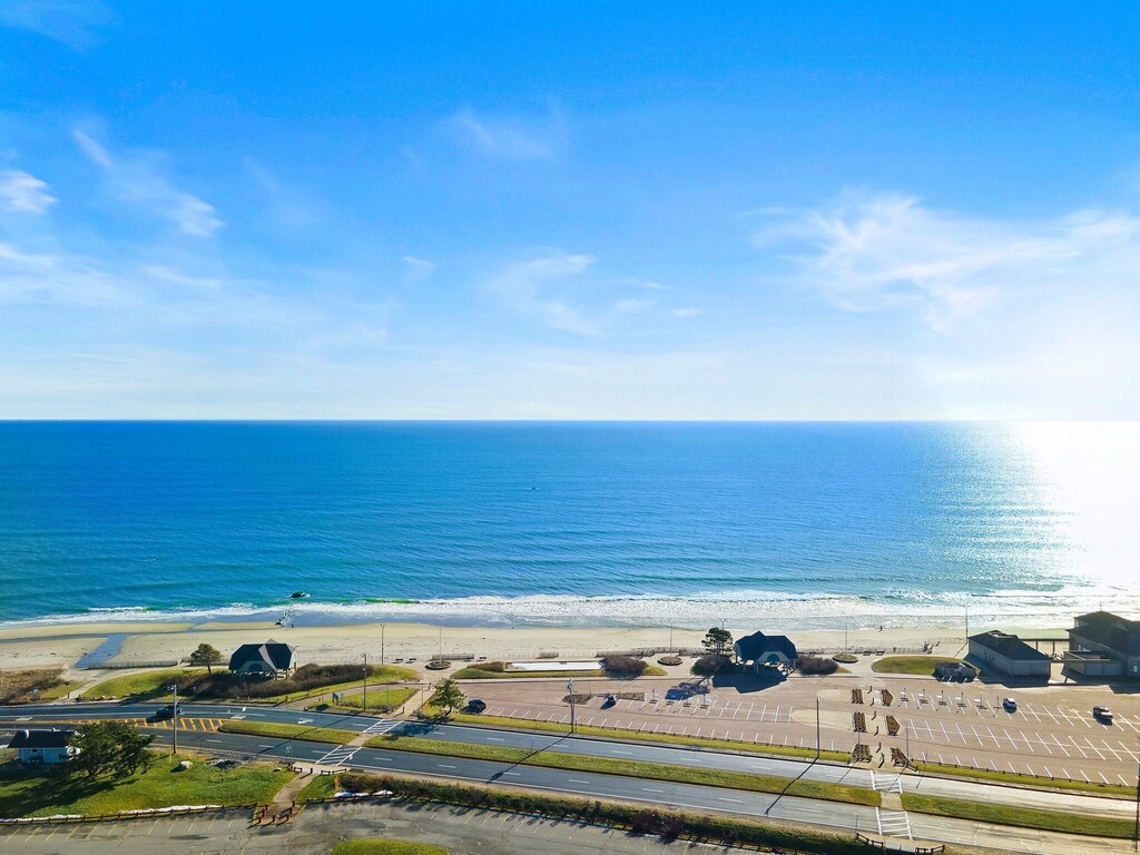 A wide, expansive view of the deep blue ocean under blue skies is seen from a Rhode Island vacation rental