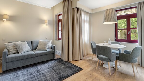 Lovely main area with a cozy sofa and bright sunlight coming in #bright #lovelystay