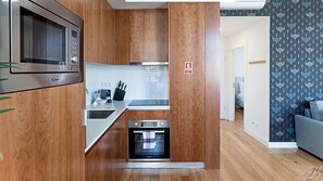 Kitchenette details: microwave, cooker, oven and other kitchen amenities.