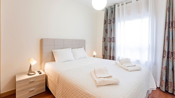 Cozy bedroom with sober decoration and a big window, providing lots of natural light #bright #cozy