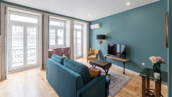 Stylish living area with a cozy sofa , TV and AC #modern #lovelystay