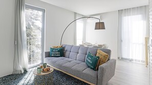 Living room with comfortable sofa-bed and big windows that allow the entrance of lots of natural light #bright #sunny #lovely