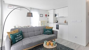 Living room with a comfortable sofa-bed, modern and simplistic decoration, AC and cable TV. You'll feel right at home in this apartment #bright #sweet #amazing