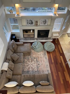 looking down to the rear sitting room, with fire place and huge sectional