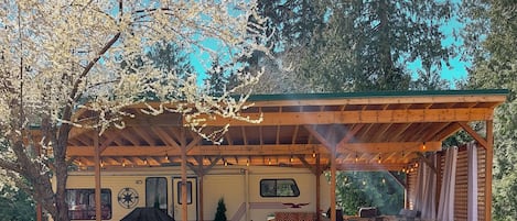 View of the Glamping Trailer during Spring when the plum tree is in bloom.