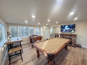 Game room with full size pool table and foosball table. 