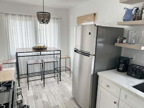 Kitchen and dining area with four seater high top table.